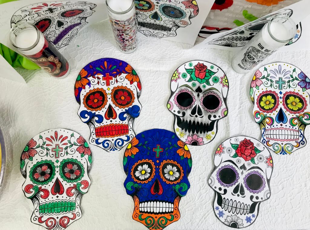 Six decorated sugar skull cutouts made by Compton Youthbuild members for Día De Los Muertos.